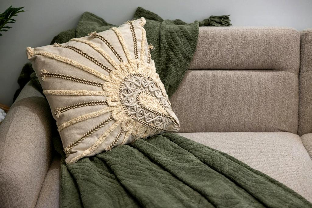 Cozy living room featuring a chunky cable-knit throw in natural wool tones